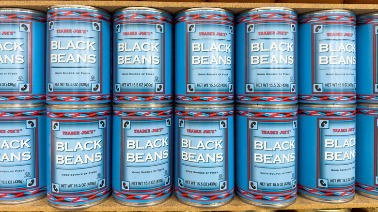 Shelf with cans of Trader Joe's black beans