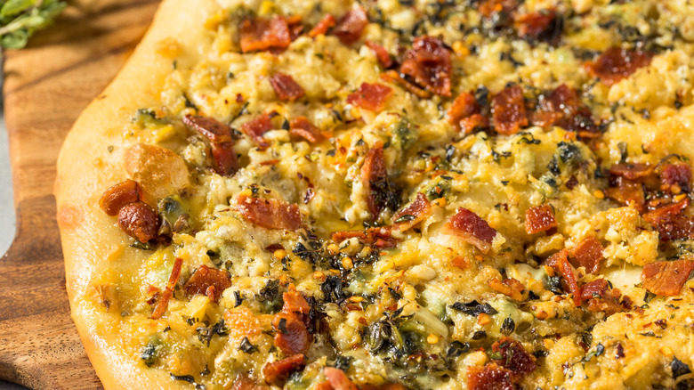 Close-up of a New Haven-style white clam pizza with bacon bits