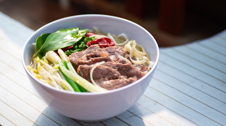 bowl of Bún Bò Huế on white table