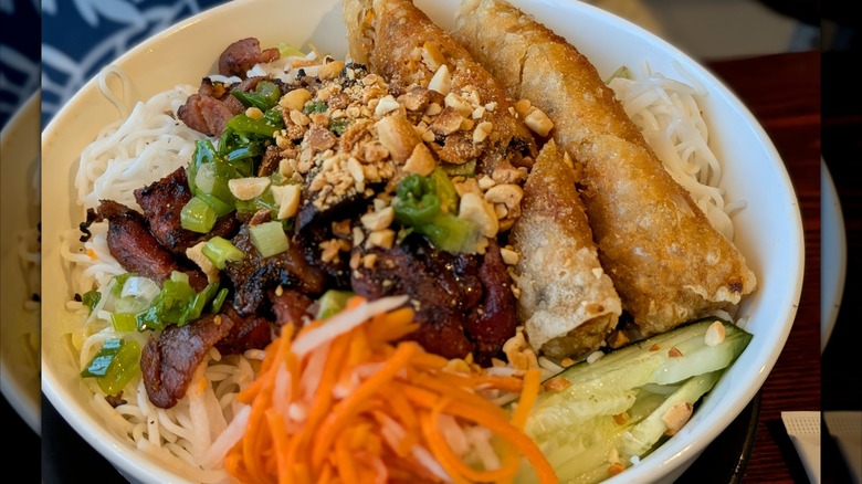 bowl of Vietnamese Grilled Pork Rice Noodles with Spring Rolls