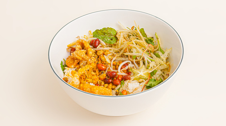 bowl of Vietnamese clam rice against white background