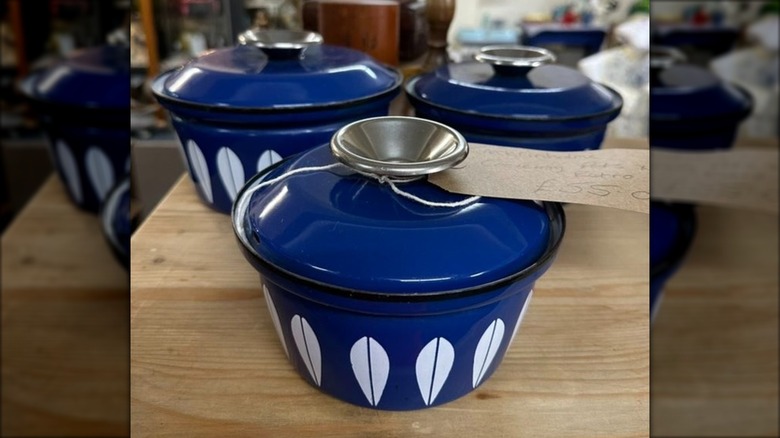 A 3-piece blue lotus Catherineholm cookware set on a wooden table