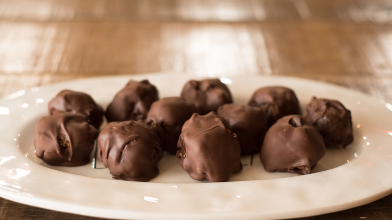 Chocolate bourbon balls on a white plate