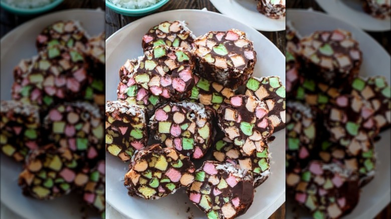 A plate of church window cookies made with colorful marmallows and chocolate on a white plate