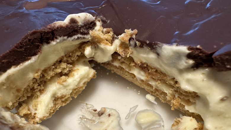 A close-up of the inside of an eclair cake made with graham crackers, pudding, and frosting