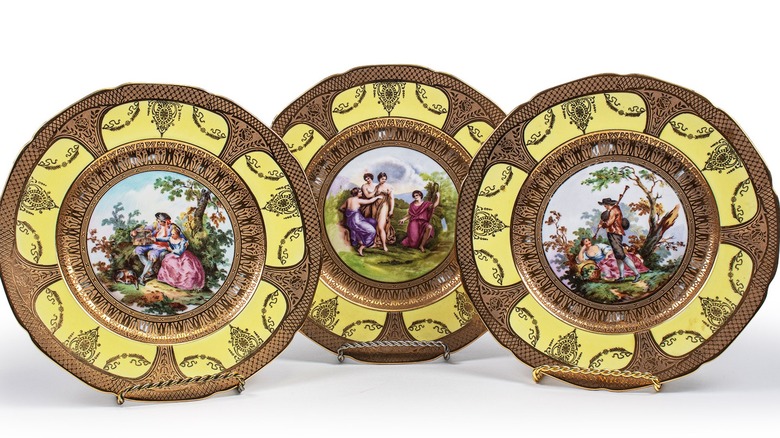 Three Limoges dinner plates with pastoral scene