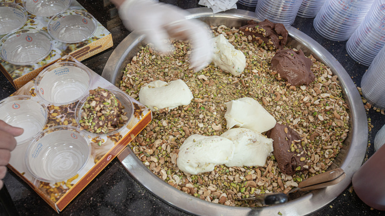 Booza ice cream and pistachio nuts in a metal bowl