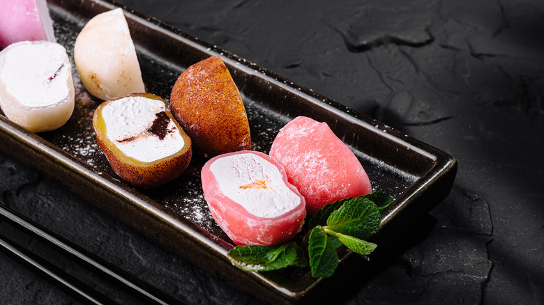 An assortment of halved mochi ice cream balls on a dish
