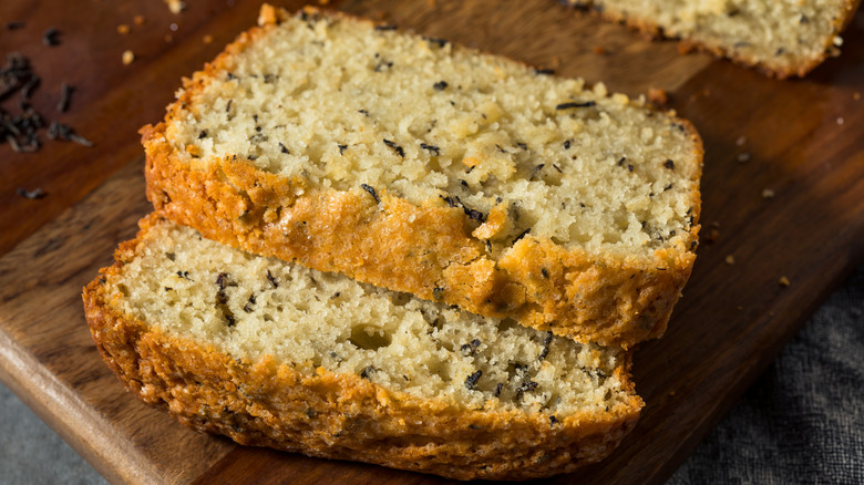 Sliced loaf of earl grey bread on wooden cutting board