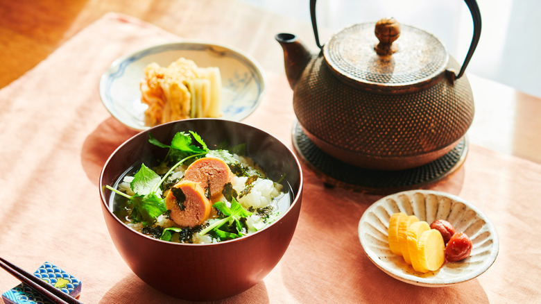 Ochazuke preparation in three bowls next to kettle