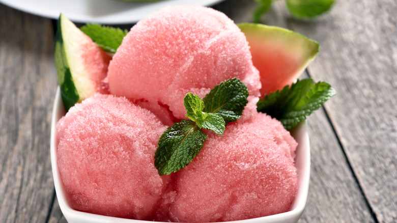 Close up of watermelon sorbet in bowl garnished with mint
