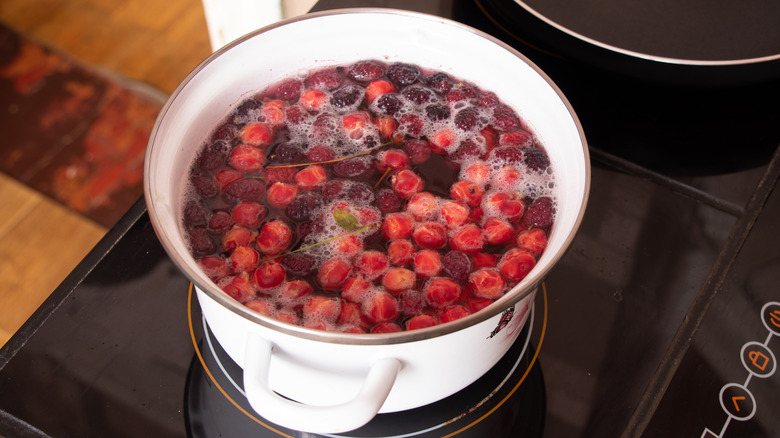 Cherry and berry compote simmering on stovetop