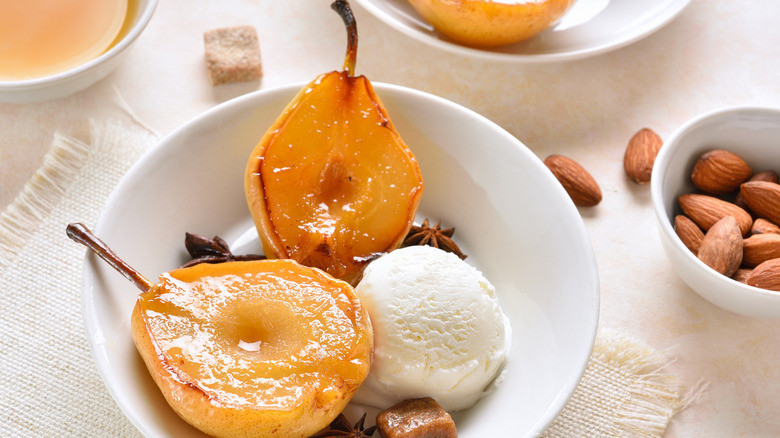 Bowl of poached pear, ice cream, and star anise