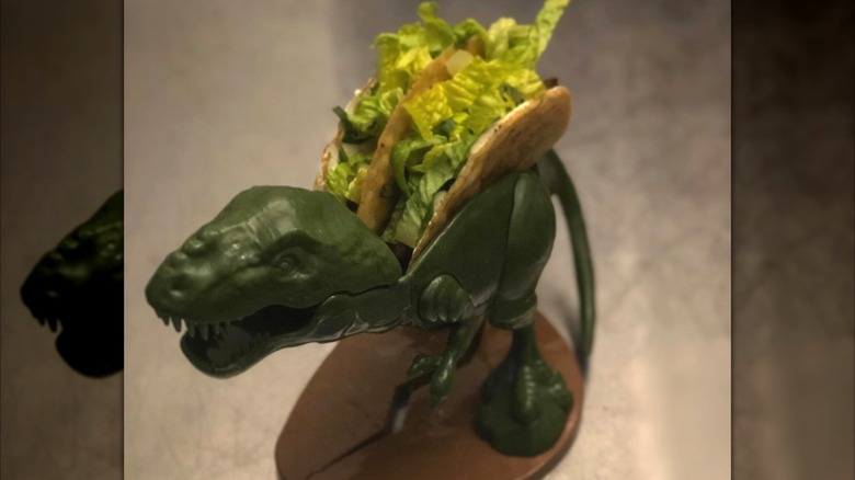 Tacos plated in toy dinosaur