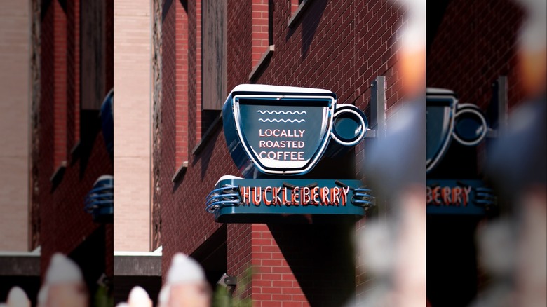 A blue sign shaped like a coffee cup