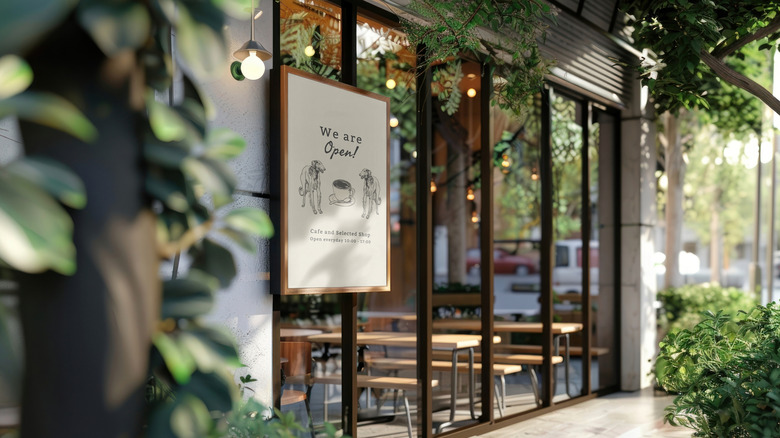 A coffee shop sign that says "We're open"