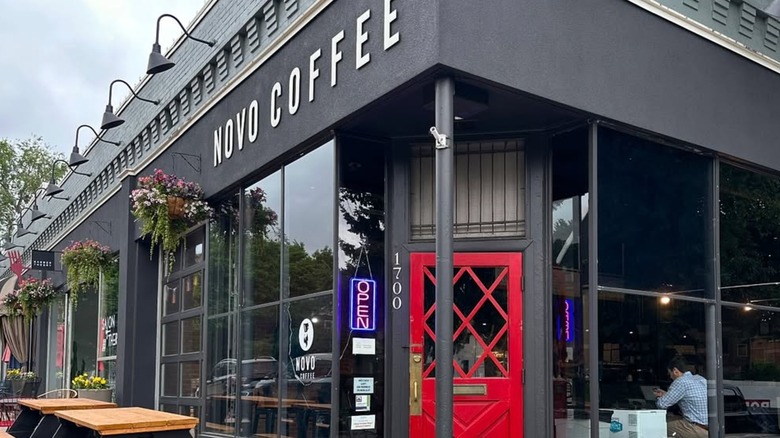 A black café facade with a red door