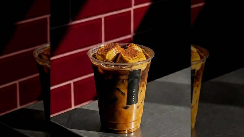 A plastic cup with coffee and toasted marshmallow