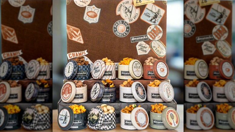 Variety of tins of various bar snacks from DM Snacks