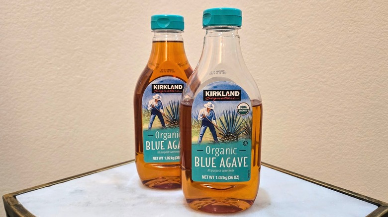 Two bottles of Kirkland Signature Organic Blue Agave on a table