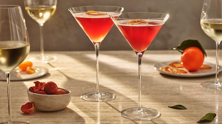 elegant martini glasses and wine glasses on a tabletop, filled with beverages