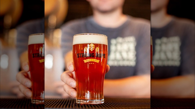 man holding a pint of beer from Strong Rope Brewery