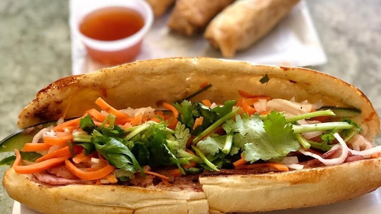 Banh mi with spring rolls and dipping sauce