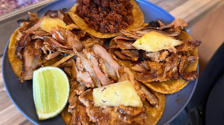 Plate full of tacos with various fillings