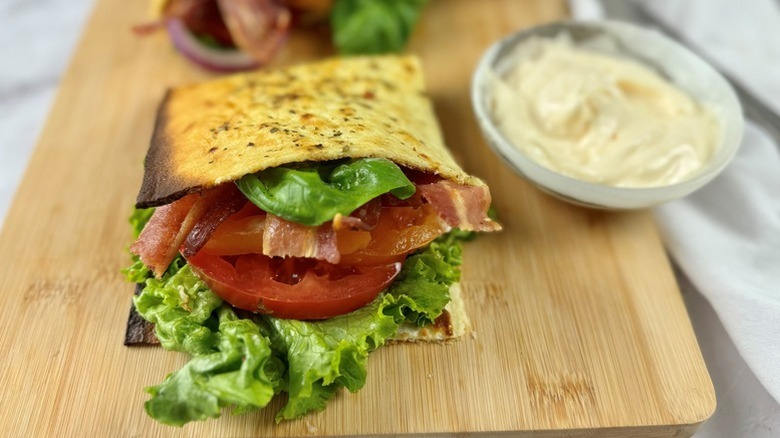 BLT wrap on wooden cutting board