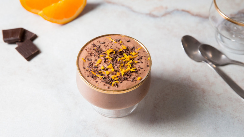 Chocolate mousse in glass, topped with shaved chocolate and orange zest