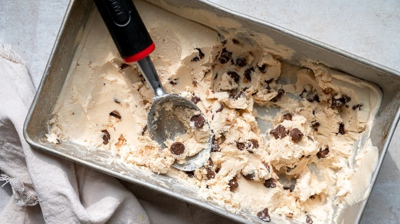 Chocolate chip ice cream in loaf pan with scoop