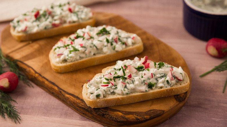 Three slices of bread topped with cottage cheese dip