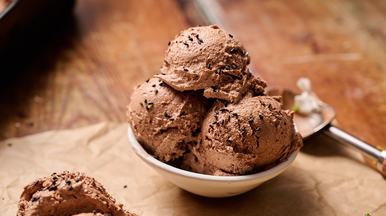 Three scoops of chocolate ice cream in bowl