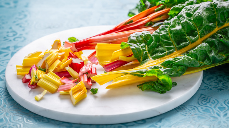 swiss chard stems chopped on a plate with whole leaves