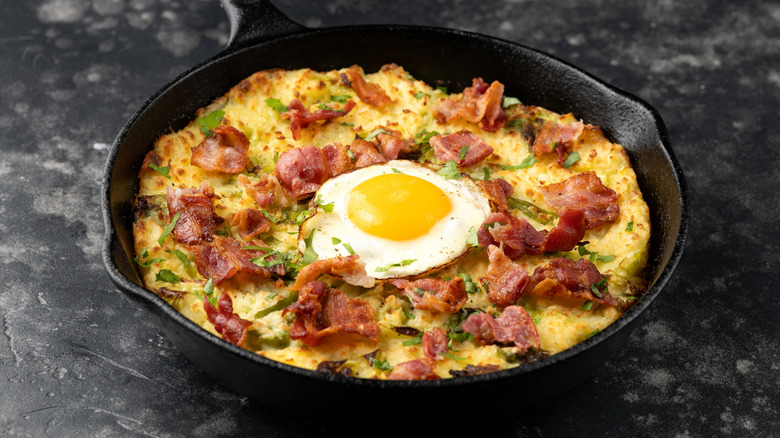 A pan of bubble and squeak with egg and bacon
