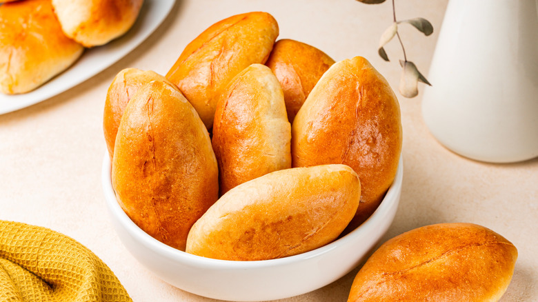 A bowl of Piroshki on a table