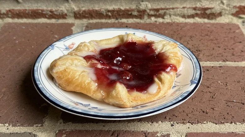 Panera Cherry pastry on a plate in front of a brick background