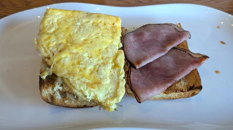 Open faced Ciabatta, Ham, and Cheese Breakfast Sandwich from Panera on a plate