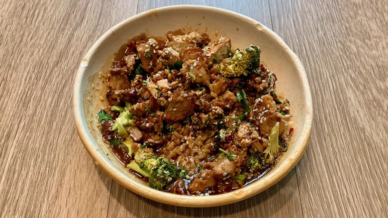 Top view of Teriyaki Chicken & Broccoli Bowl in a ceramic bowl on a wooden table