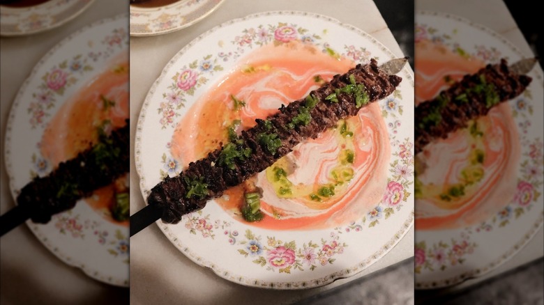 beef dish on ornate plate at Shmoné NYC