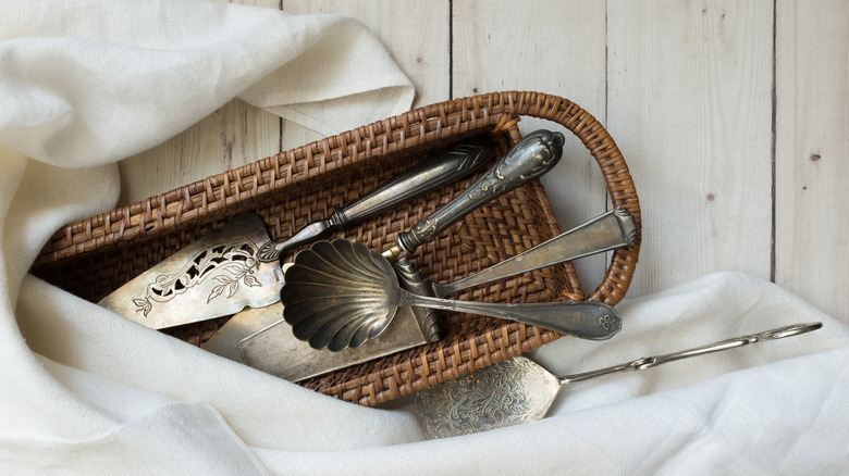 antique silverware in a basket