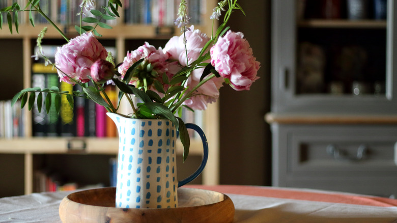 kitchen pitcher with flowers in on table