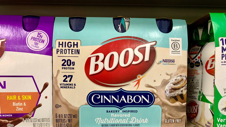 A carton of Boost nutritional shakes on a shelf with the price.