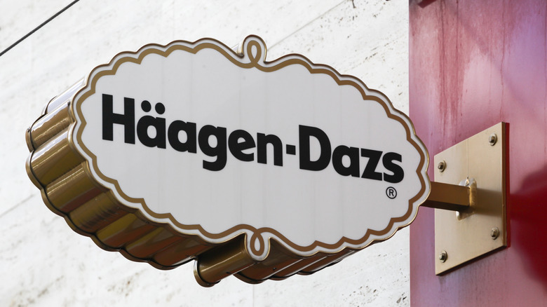 A Häagen-Dazs slogan sign outside of an ice cream shop.