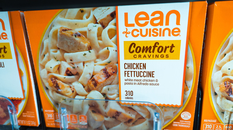 A box of lean cuisine is pictured on a shefl.