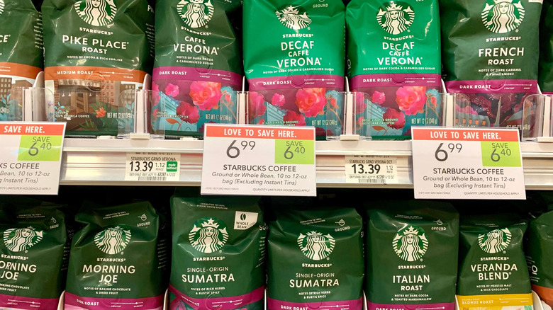 Several varieties of Starbucks packaged beans on the shelf at the grocery store.