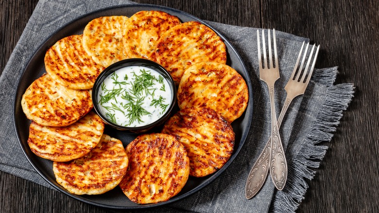 Plate of savory cheese pancakes with creamy dill dip