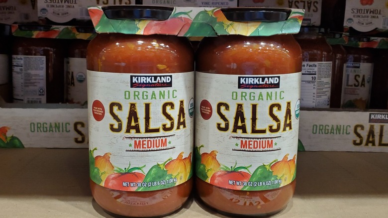 Two jars of Kirkland Signature organic medium salsa on a shelf at Costco
