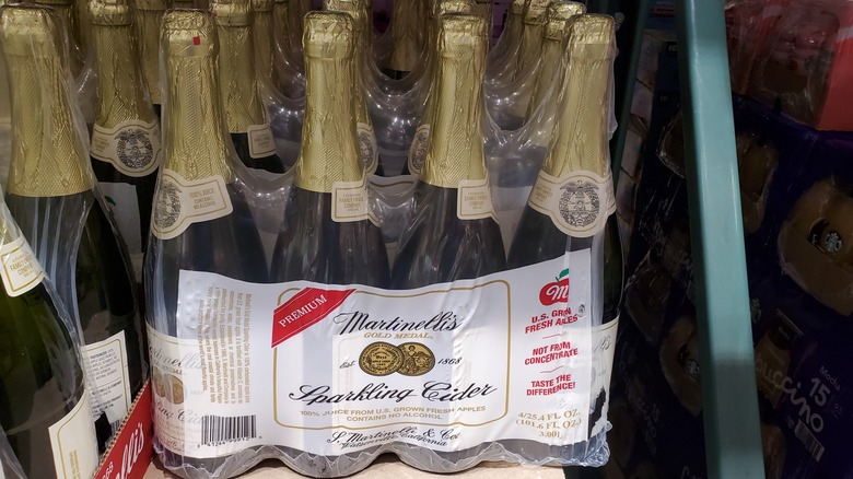 Four wrapped bottles of Martinelli's Gold Medal sparkling cider