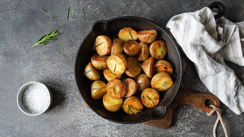 Potatoes roasting in a cast-iron skillet